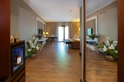 a hotel room with a hallway with a living room at Ramada by Wyndham Istanbul Merter in Istanbul