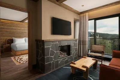 a living room with a fireplace and a television at Ceylan Splend'or Uludag, Autograph Collection
