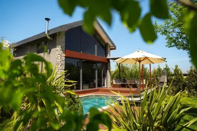a house with a swimming pool and an umbrella at Monk Living Space in Kocaeli