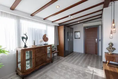 a living room with a wooden cabinet and windows at Romantic Hotel Istanbul in Istanbul