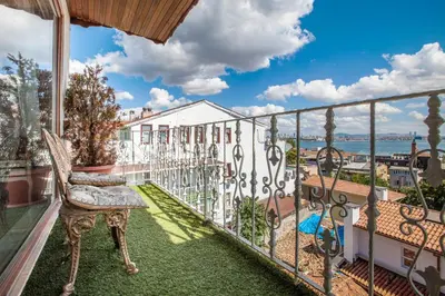 a balcony with a chair and a view of the ocean at Romantic Hotel Istanbul in Istanbul