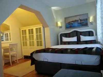 a bedroom with a bed and a desk in a room at Hotel Taksim Home in Istanbul