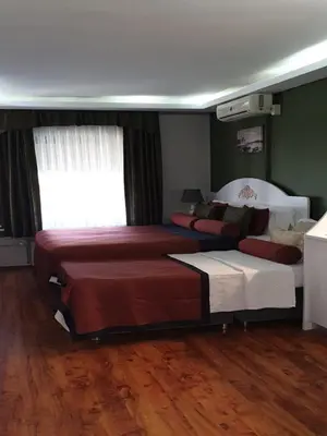 a bedroom with a large bed and a couch at Hotel Taksim Home in Istanbul