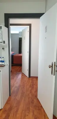 a room with white doors and a wooden floor at Hotel Taksim Home in Istanbul