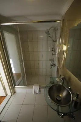 a bathroom with a sink and a shower at Hotel Taksim Home in Istanbul