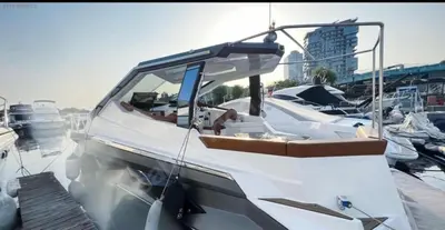 a white boat is docked in a harbor at mrsMERİMA in Bursa