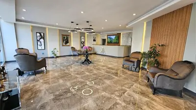 a lobby with chairs and a table in a room at Altınova Hotel Sakarya in Serdivan