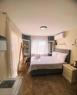 a bedroom with a bed and a staircase in it at Büyükada Çarşı Pansiyon in Adalar
