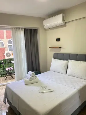 a hotel room with a bed with towels on it at Büyükada Çarşı Pansiyon in Adalar