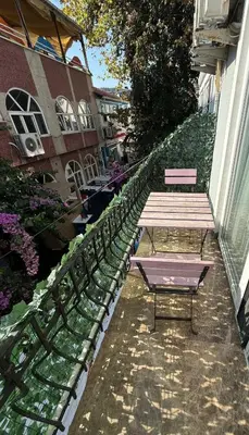 a bench sitting on the side of a building at Büyükada Çarşı Pansiyon in Adalar