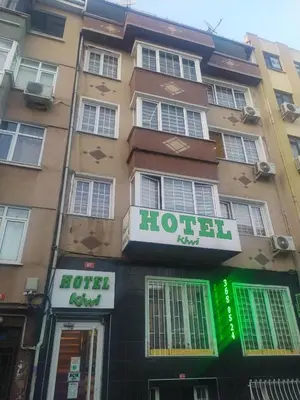 a hotel with a hotel sign in front of a building at Hotel Kiwi in Istanbul