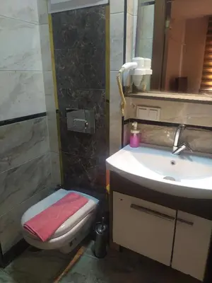 a bathroom with a sink and a toilet and a mirror at Hotel Kiwi in Istanbul