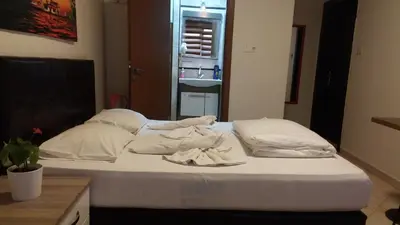 a bed with white sheets and pillows in a room at Hotel Kiwi in Istanbul