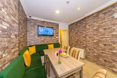 a dining room with a wooden table and chairs at Walnut Shell Hotel in Istanbul