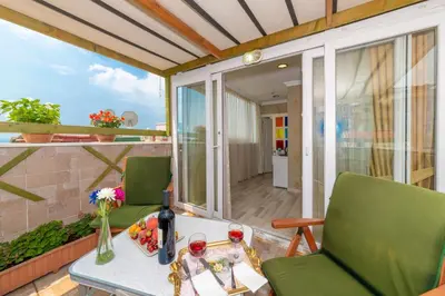 a balcony with a table and two green chairs at Walnut Shell Hotel in Istanbul