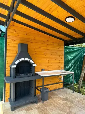 a outdoor pizza oven in a wooden building at Finymoco in Kartepe