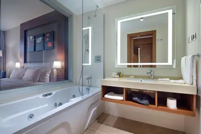 a bathroom with a tub and a sink and a mirror at Hilton Garden Inn Istanbul Beylikduzu in Istanbul