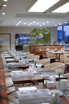 a row of tables and chairs in a restaurant at Hilton Garden Inn Istanbul Beylikduzu in Istanbul