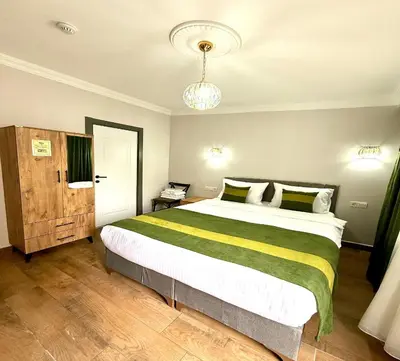 a bedroom with a large bed and a chandelier at Armagan Home Taksim in Istanbul