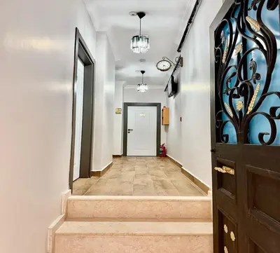 a hallway with a door and a stairway at Armagan Home Taksim in Istanbul
