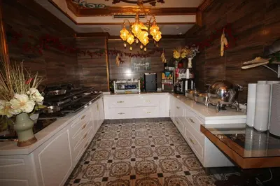 a large kitchen with white cabinets and a counter at Laleli Blue Marmaray Hotel in Istanbul
