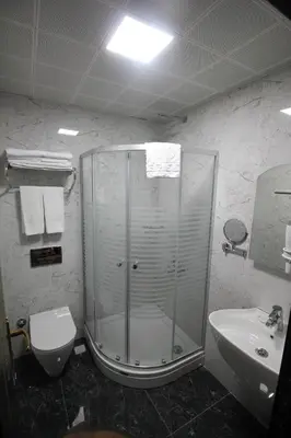 a bathroom with a shower and a toilet and a sink at Laleli Blue Marmaray Hotel in Istanbul