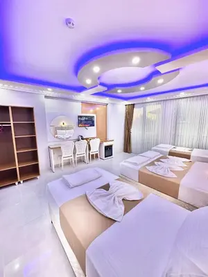 a bedroom with three beds and a dining room at Hagia Sophia Palace Hotel in Istanbul