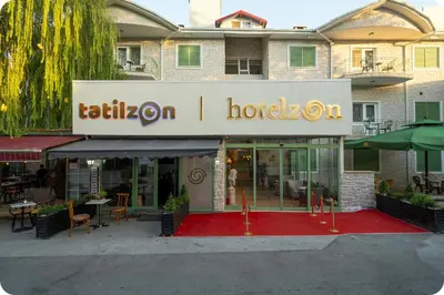 a hotel with a red carpet in front of a building at Hotel Zon in Serdivan