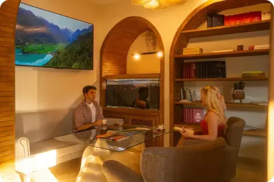a man and a woman sitting in a living room at Hotel Zon in Serdivan