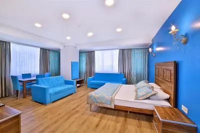 a bedroom with blue walls and a bed and blue furniture at The Hera Premium Hotels in Istanbul