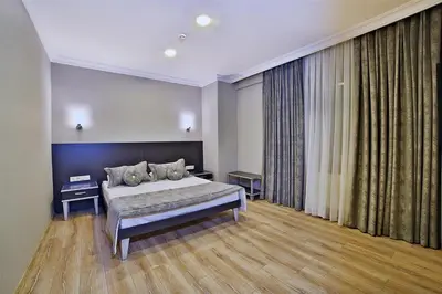 a bedroom with a bed and a large window at The Hera Premium Hotels in Istanbul