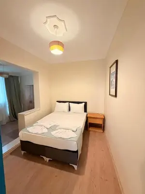a bedroom with a large bed and a light at walkabout apart in Istanbul