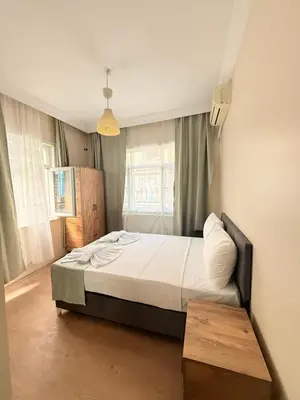 a bedroom with a bed and a window at walkabout apart in Istanbul