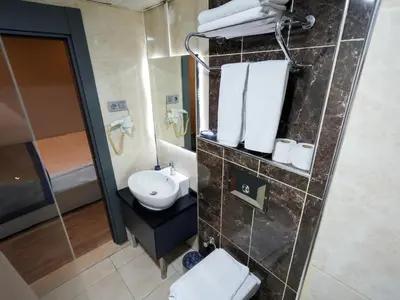 a bathroom with a sink and a toilet and a mirror at No 139 Apartments in Istanbul