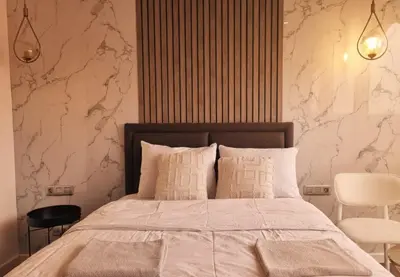 a bedroom with a large bed with white sheets at Dap Vazo Kule Rezidansta Konaklama Hizmeti in Istanbul