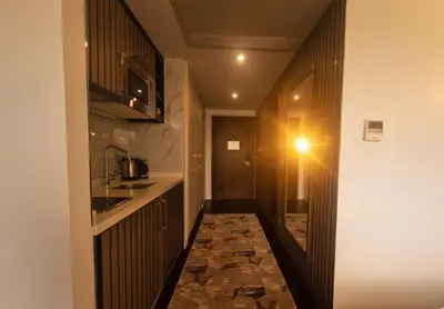 a small kitchen with a counter and a light on the wall at Dap Vazo Kule Rezidansta Konaklama Hizmeti in Istanbul