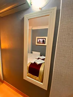 a mirror in a room with a bed in it at Santefe Hotel in Istanbul