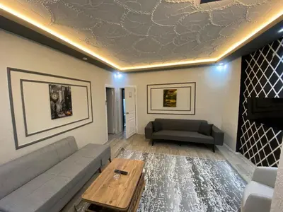 a living room with a couch and a table at Poyraz suit in Bursa