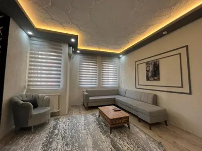 a living room with a couch and a table at Poyraz suit in Bursa