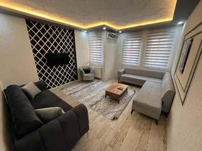 a living room with a couch and a table at Poyraz suit in Bursa