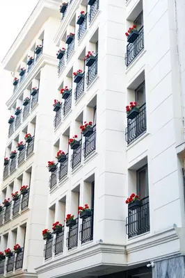 a facade of a hotel with flower boxes on balconies at Istanbul Taksim Pera Star Hotel - Istiklal Street in Istanbul