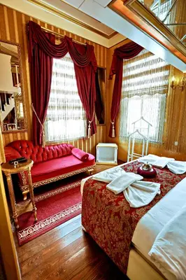 a bedroom with two beds and a couch in it at Sultan Suites Hotel in Istanbul