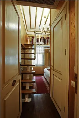 a room with a staircase and a room with a bed at Sultan Suites Hotel in Istanbul