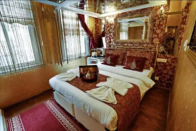 a bedroom with two beds and a mirror at Sultan Suites Hotel in Istanbul
