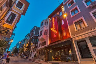 a city street with buildings and people walking down the street at Taksim Istanbul Nis Hotel - Istiklal Street in Istanbul
