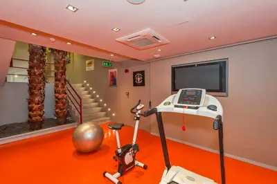 a room with a treadmill and a tv and stairs at Taksim Istanbul Nis Hotel - Istiklal Street in Istanbul