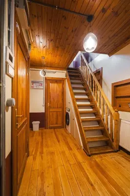 a hallway with a wooden staircase in a house at Mercan Apartments Balat-The Hidden Terrace in Istanbul