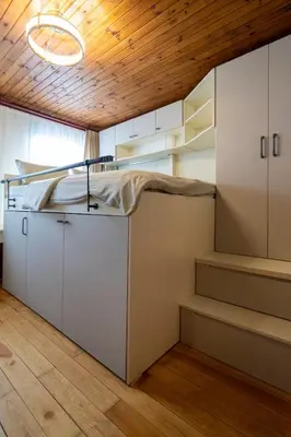a room with a bed and stairs in it at Mercan Apartments Balat-The Hidden Terrace in Istanbul