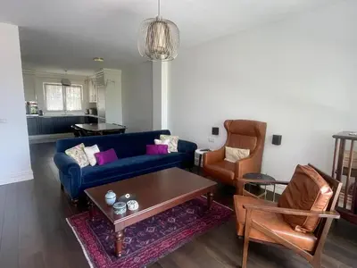 a living room with a blue couch and chairs at Villa Orange in Istanbul