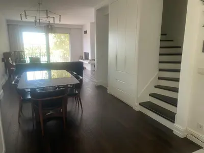 a dining room with a table and chairs and a staircase at Villa Orange in Istanbul